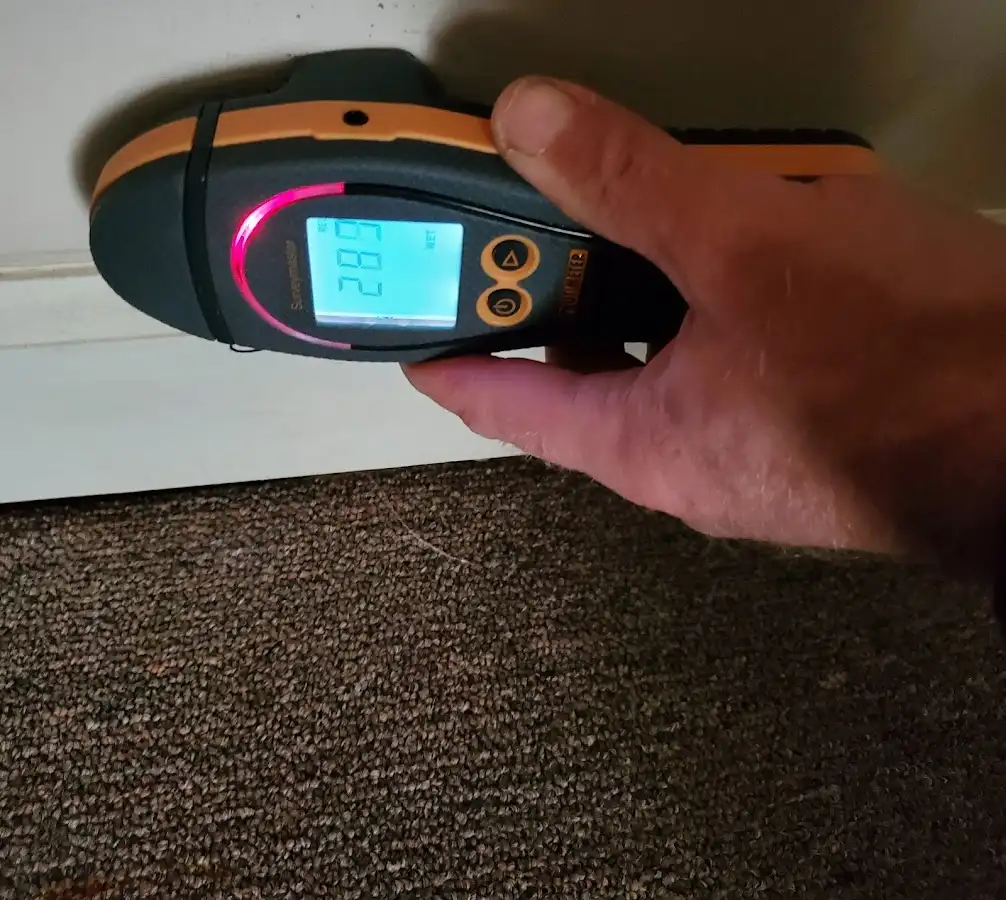 Moisture detection at baseboard during Storm Damage Restoration in Monroe